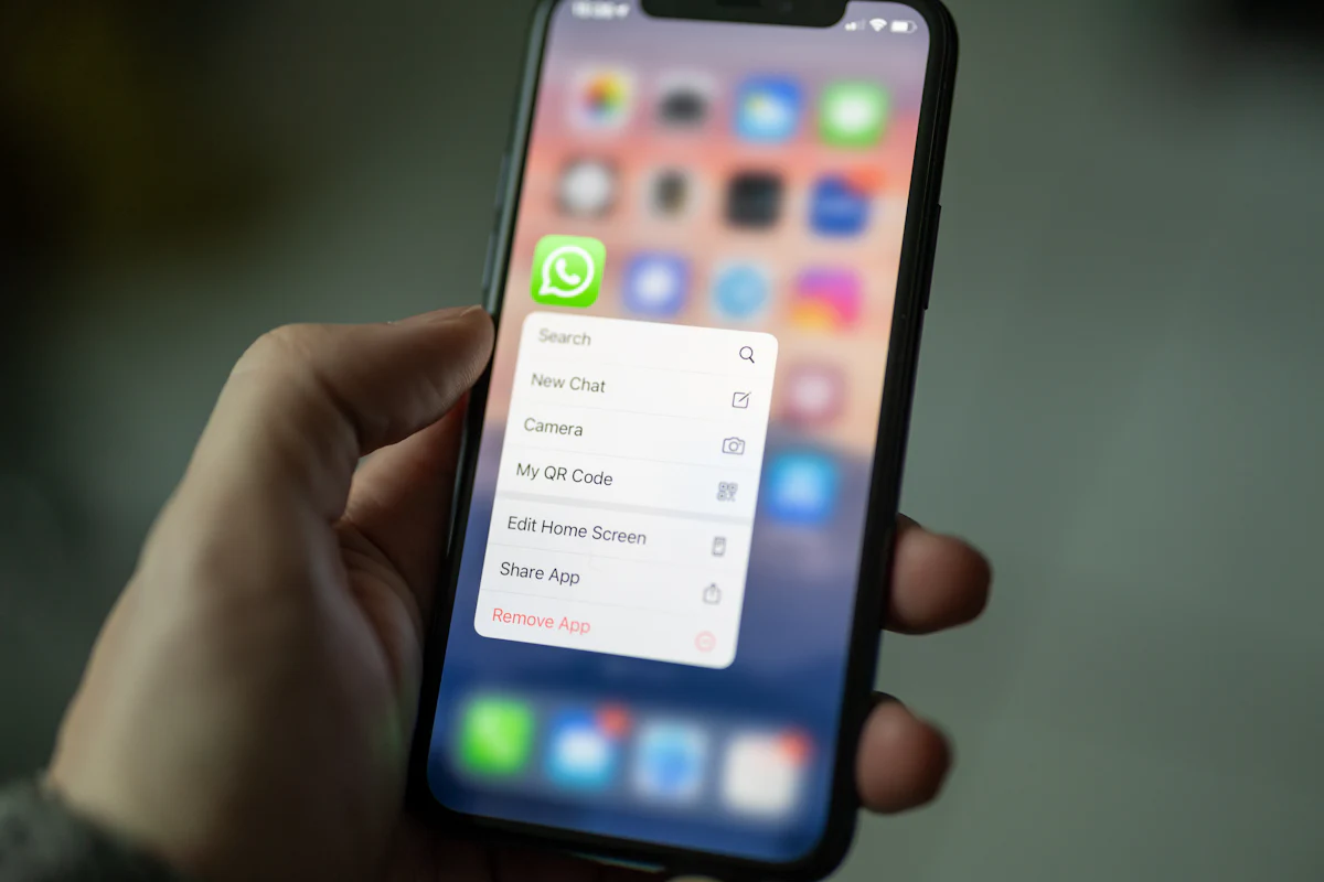 Hand holding a phone with a messaging app open